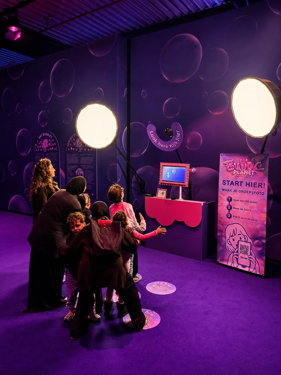 Guests taking a group photograph at the Bubble Planet Studio capture point